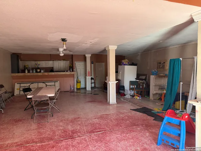 a room with furniture a flat screen tv and a table