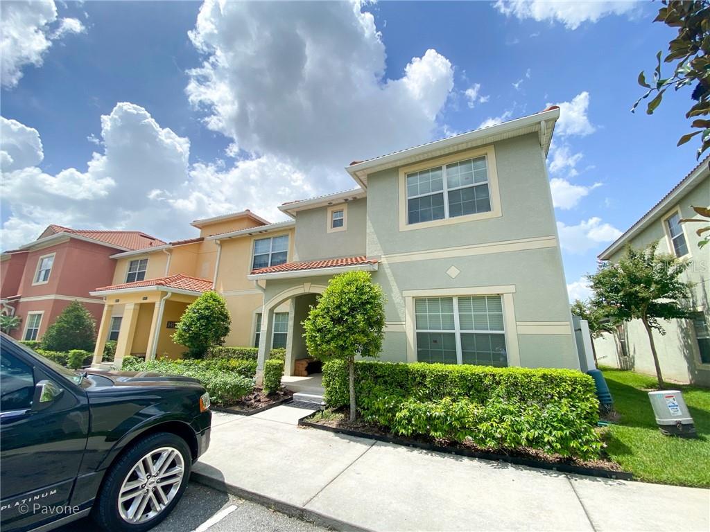 8887 Candy Palm Road Kissimmee, FL 34747 - Photo 1 of 1 a front view of a house with a garden