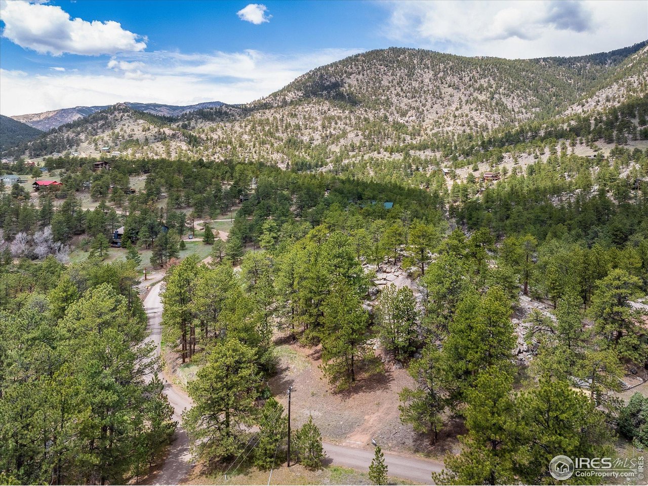 1289 Kiowa Road Lyons, CO 80540 - Photo 19 of 37 a view of a field with mountains in the background