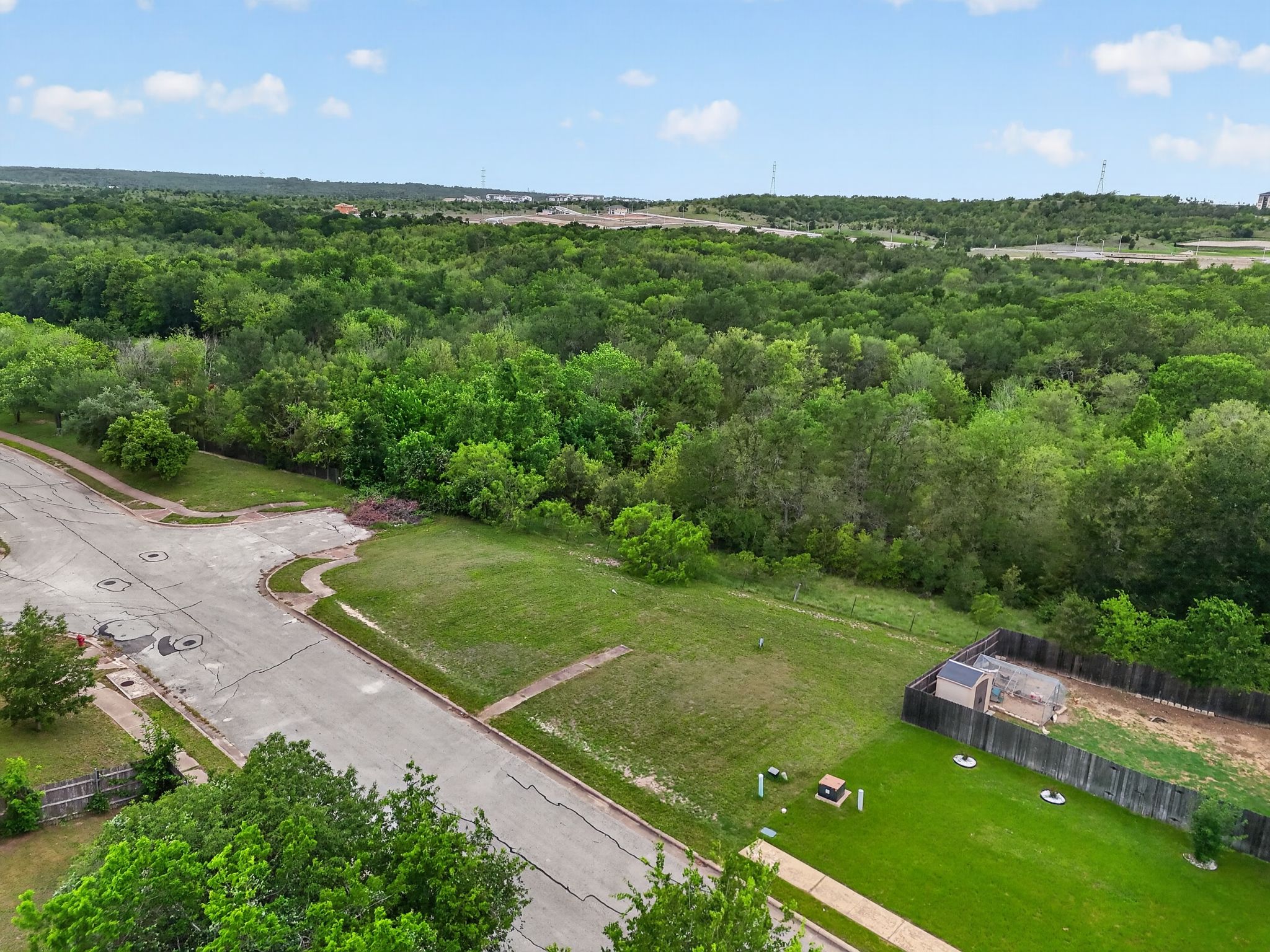 11908 Athens Street Manor, TX 78653 - Photo 2 of 15 Expansive lot with a well-maintained lawn and a wooden fence