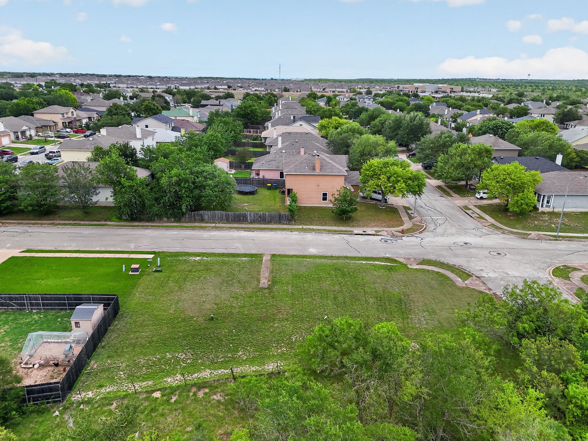 11908 Athens Street Manor, TX 78653 - Photo 3 of 15 Expansive green space featuring a partially mowed lawn, a shed, and fencing