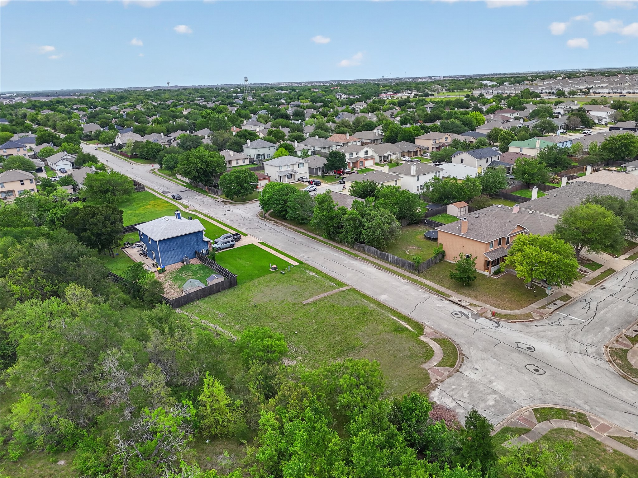 11908 Athens Street Manor, TX 78653 - Photo 7 of 15 An aerial view showcasing the property's location within a developed neighborhood, featuring residential streets and mature trees