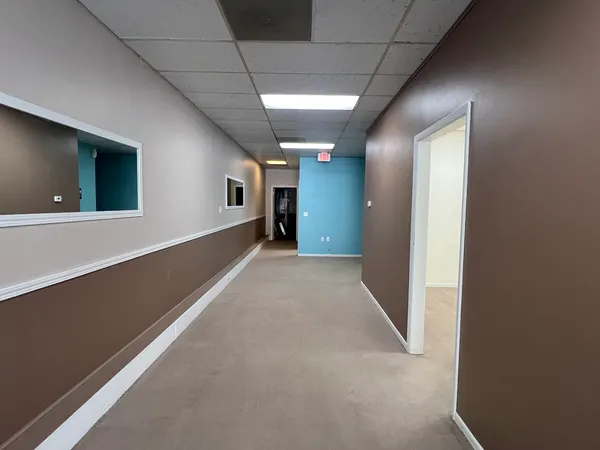 a view of hallway with wooden floor