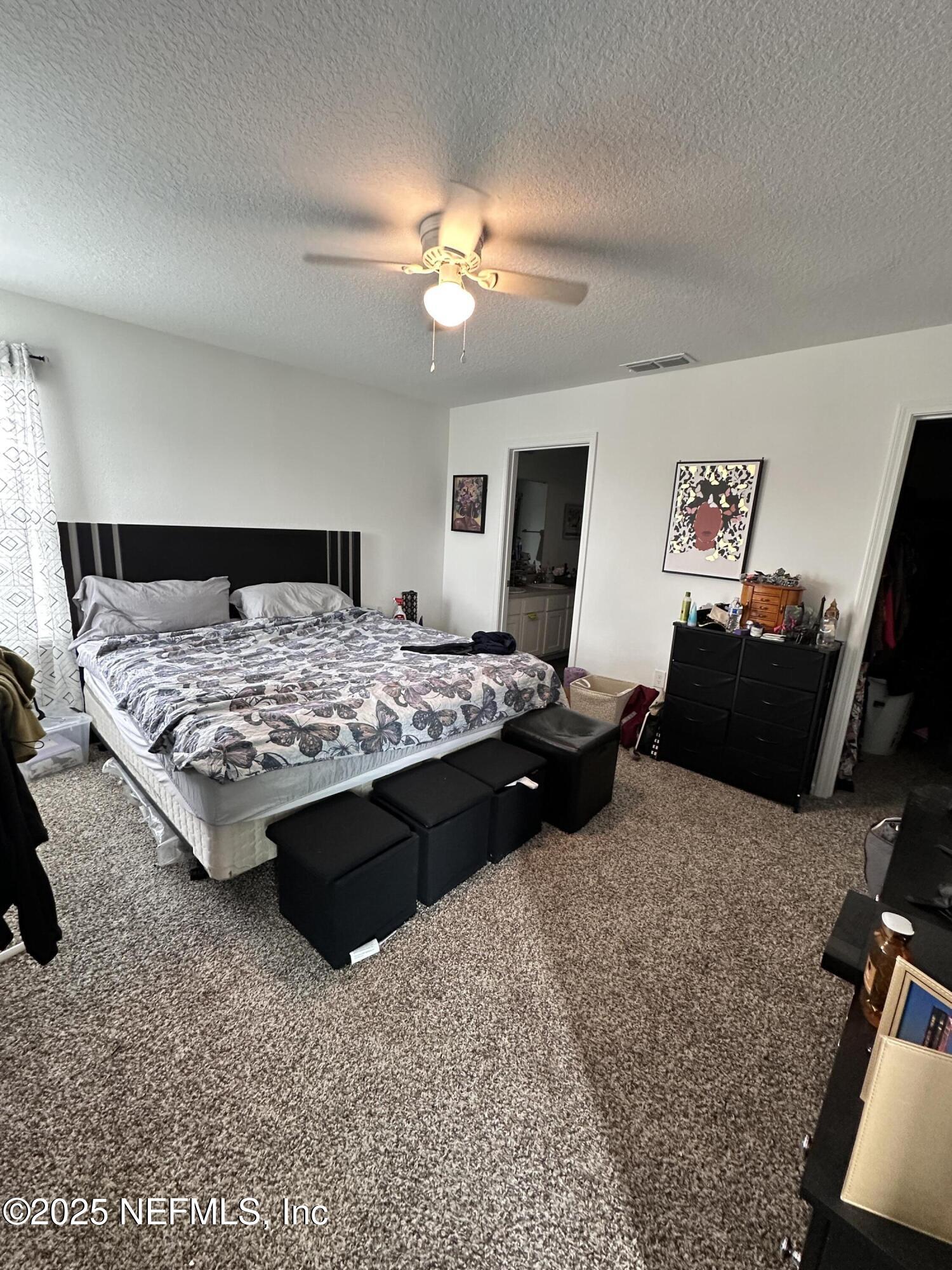 2769 Oak Strm Drive Green Cove Springs, FL 32043 - Photo 11 of 17 a bedroom with a bed and dresser with mirror