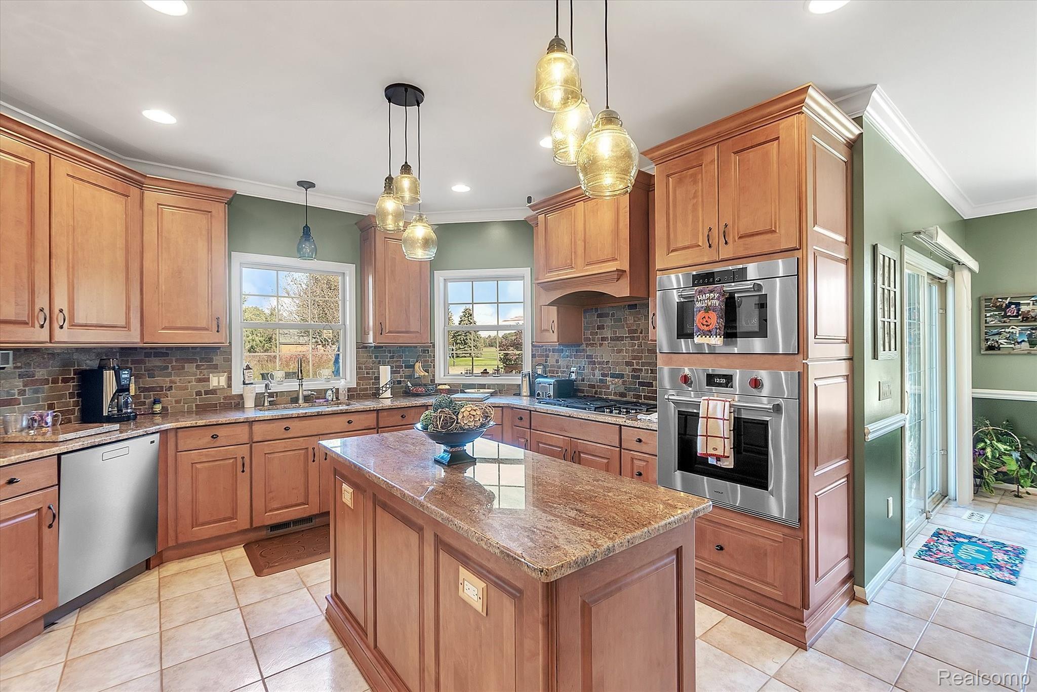 2350 Granger Road Oxford, MI 48371 - Photo 16 of 85 Kitchen with granite counter-tops, stainless steel appliances, and custom cabinetry