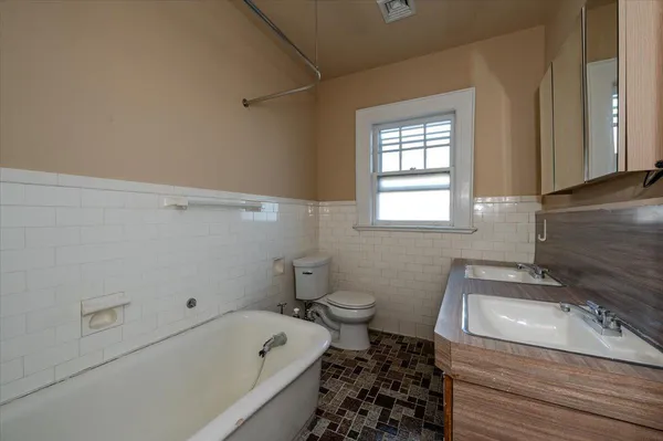 a bathroom with a sink a toilet and bathtub