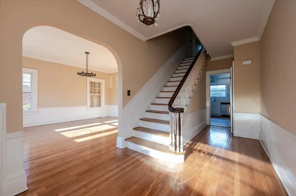 a view of entryway and hall with wooden floor