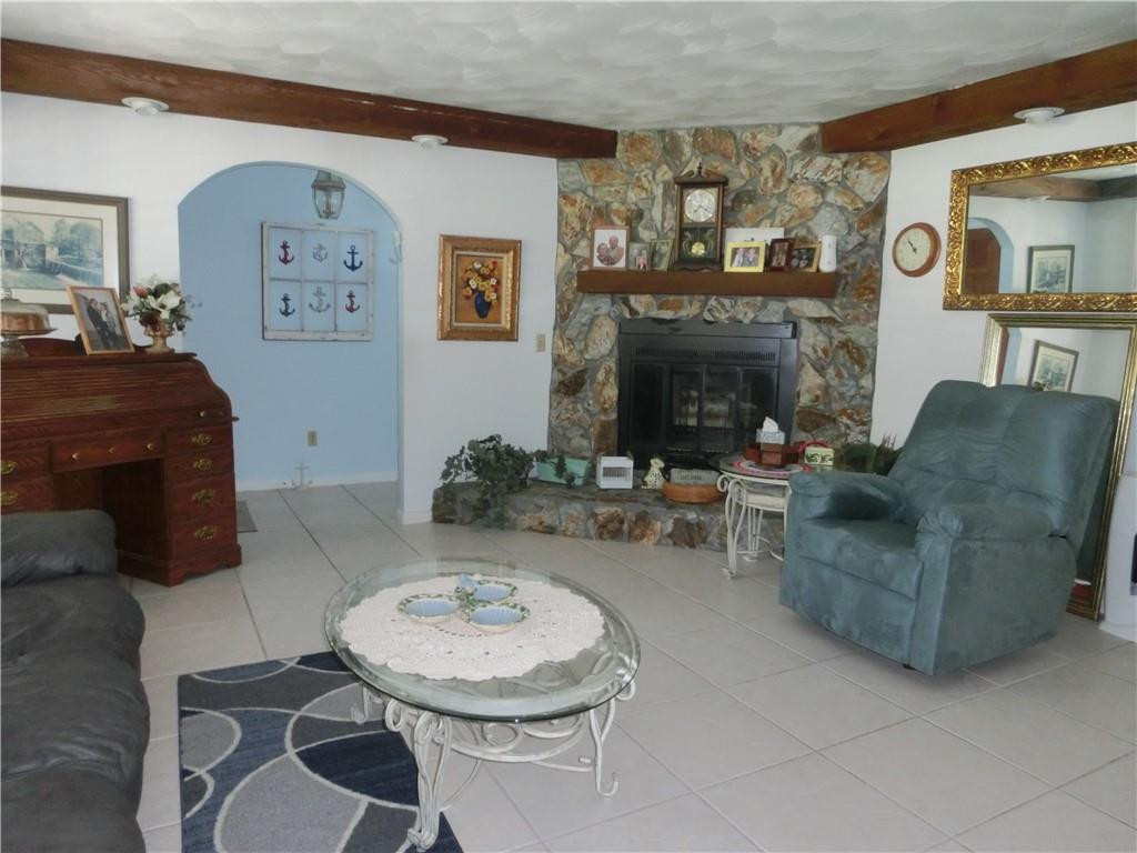 590 Southwest Harbor Street Stuart, FL 34997 - Photo 8 of 14 LIVING ROOM WITH WOOD BURNING FIREPLACE