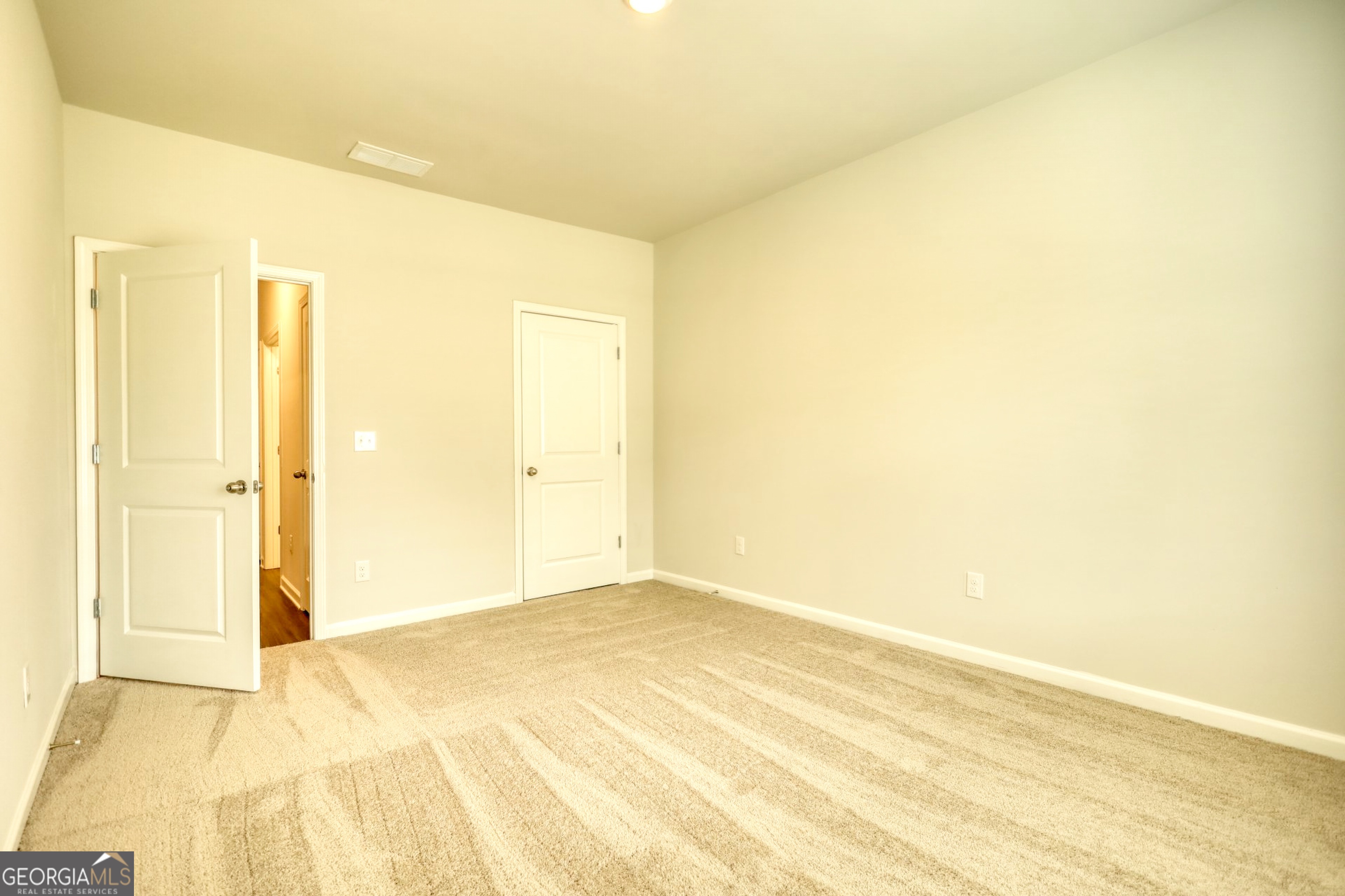 815 Crossroads Court Social Circle, GA 30025 - Photo 2 of 3 a view of a big room with wooden floor and a window