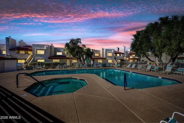 a view of a swimming pool with a lounge chairs