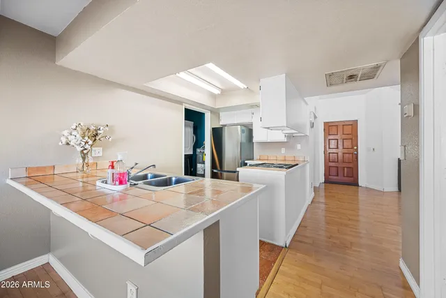 a kitchen with stainless steel appliances granite countertop a stove and a refrigerator