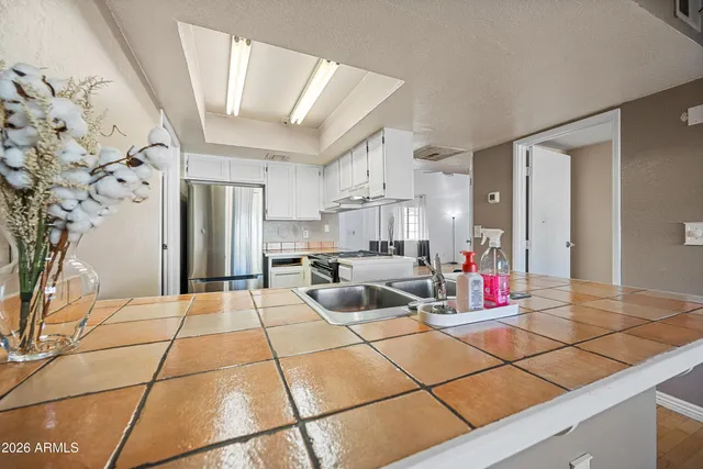 a kitchen with kitchen island a sink appliances and cabinets