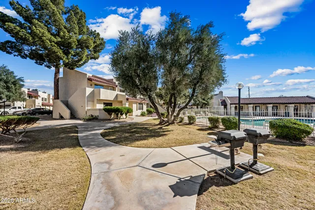 a view of a backyard with sitting area
