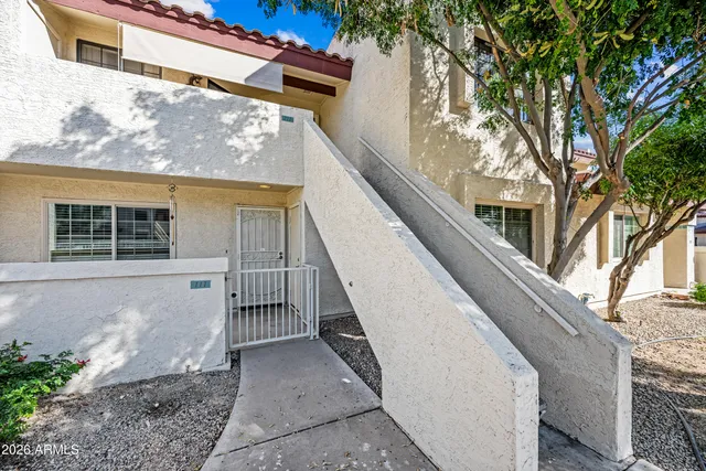 a flower garden with a bench in front of it