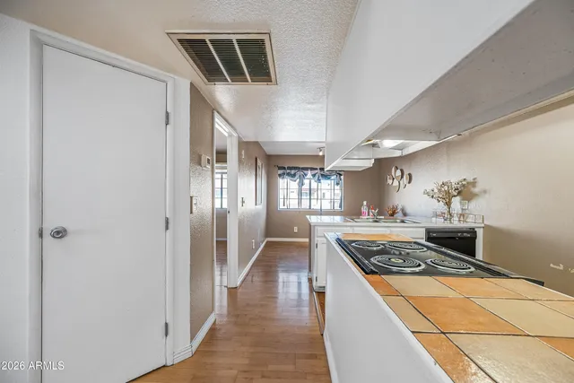 a bedroom with a bed closet and wooden floor