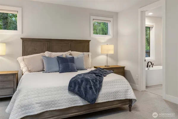 a bedroom with a bed and a night stand
