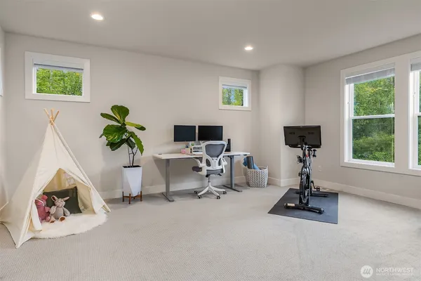 a view of a livingroom with workspace and a window