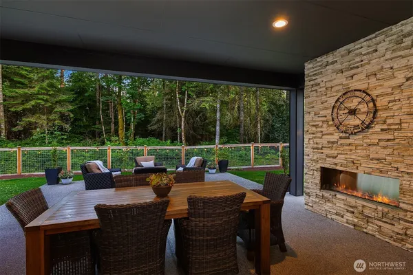 a view of a patio with a table chairs and a backyard