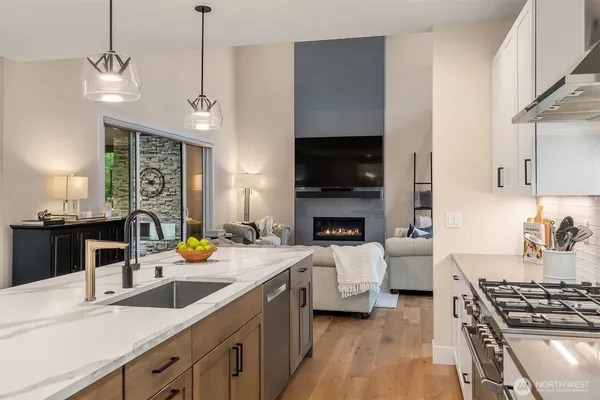 a kitchen with sink stove and cabinets