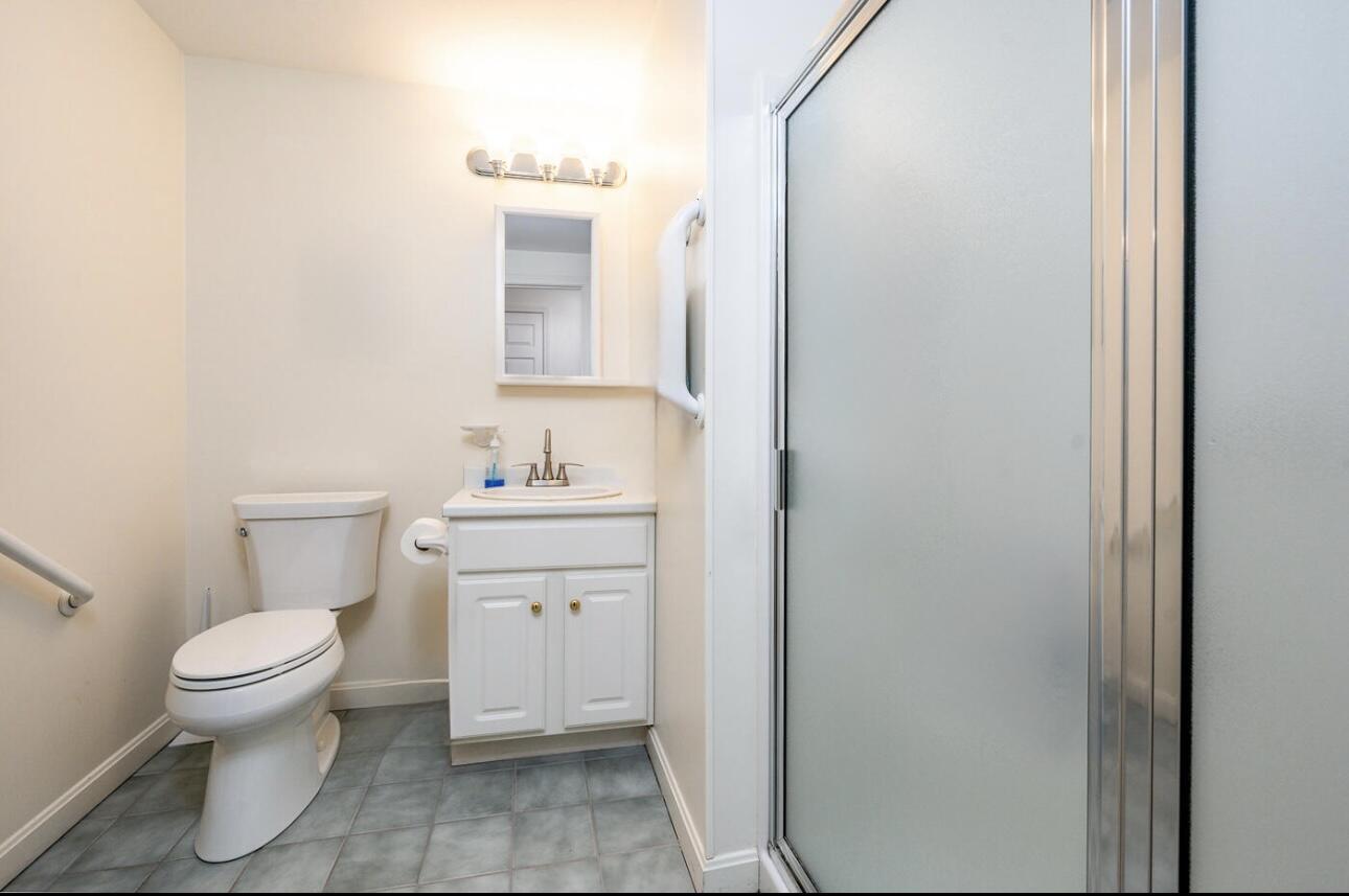 5 Friendship Court Mashpee, MA 02649 - Photo 14 of 32 a bathroom with a toilet sink and a mirror