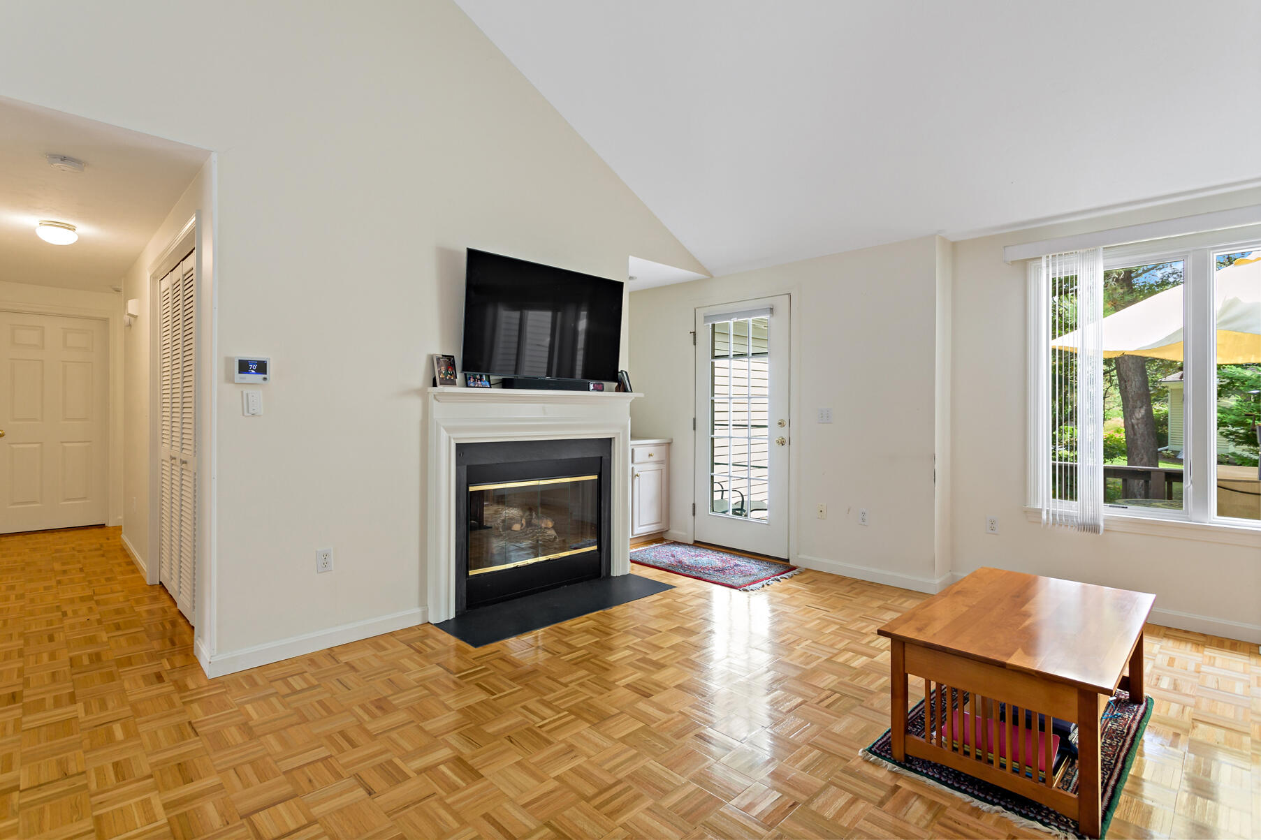 5 Friendship Court Mashpee, MA 02649 - Photo 7 of 32 a living room with furniture a flat screen tv and a fireplace