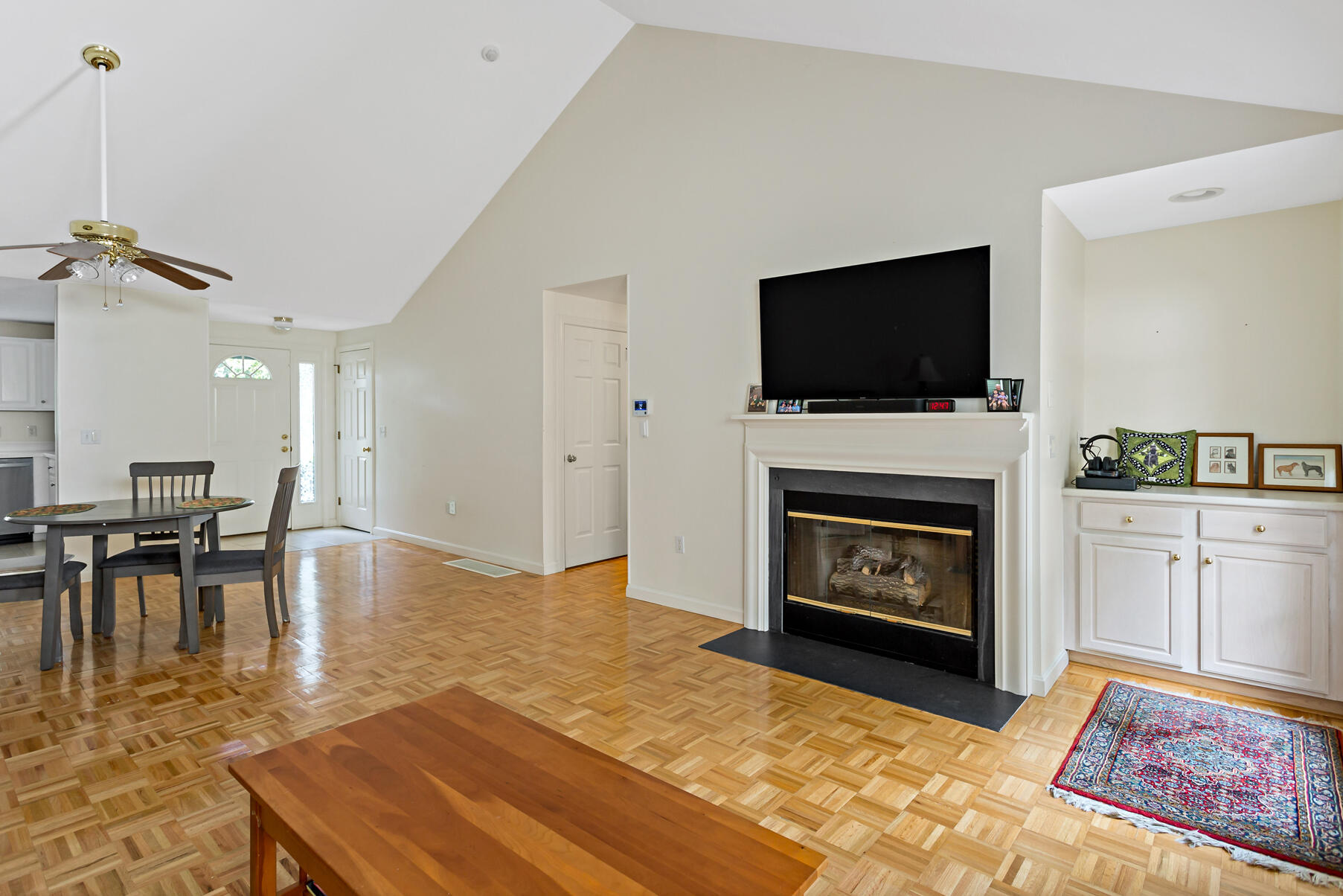 5 Friendship Court Mashpee, MA 02649 - Photo 8 of 32 a living room with furniture a flat screen tv and a fireplace
