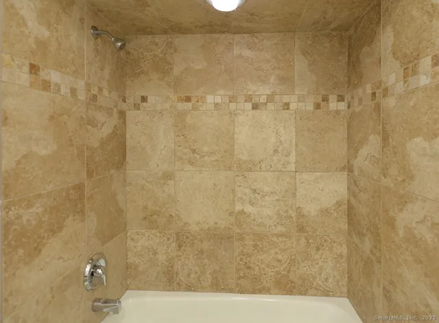 a bathroom with a bathtub and shower