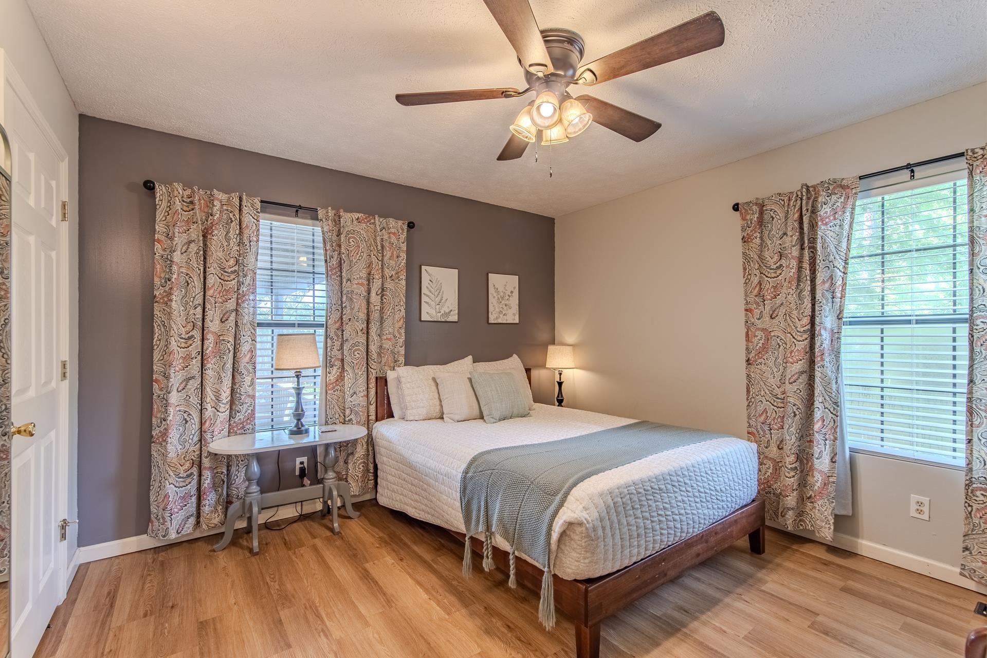 15 Lilly Cove Counce, TN 38326 - Photo 19 of 39 a bedroom with a large bed and a large window