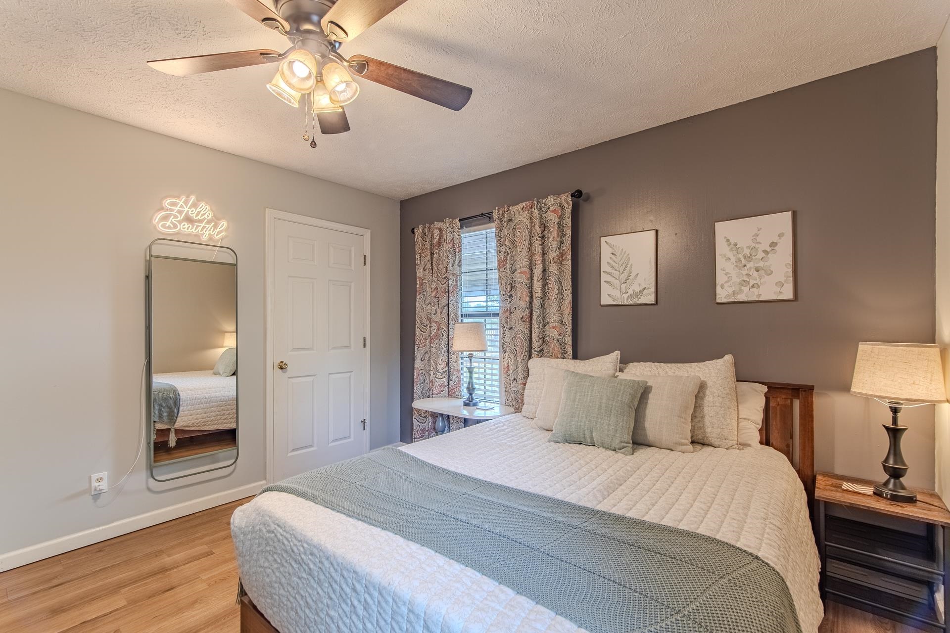 15 Lilly Cove Counce, TN 38326 - Photo 20 of 39 a bedroom with a large bed and a chandelier