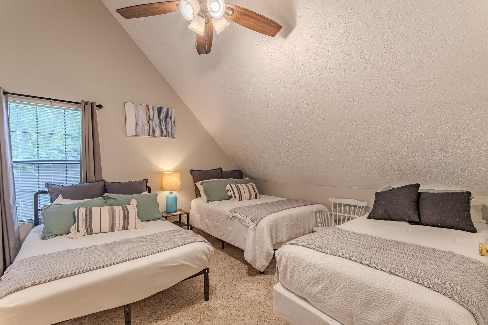 15 Lilly Cove Counce, TN 38326 - Photo 26 of 39 a bedroom with two beds and a chandelier