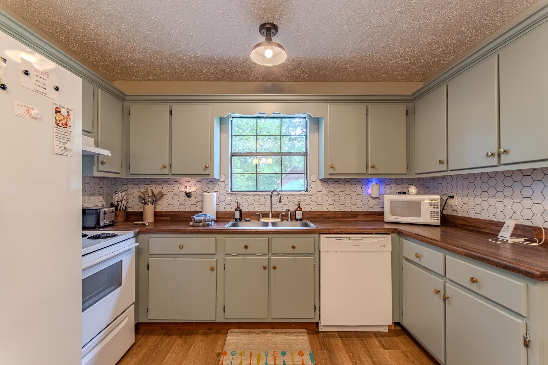 15 Lilly Cove Counce, TN 38326 - Photo 4 of 39 a kitchen with cabinets appliances a sink and a window