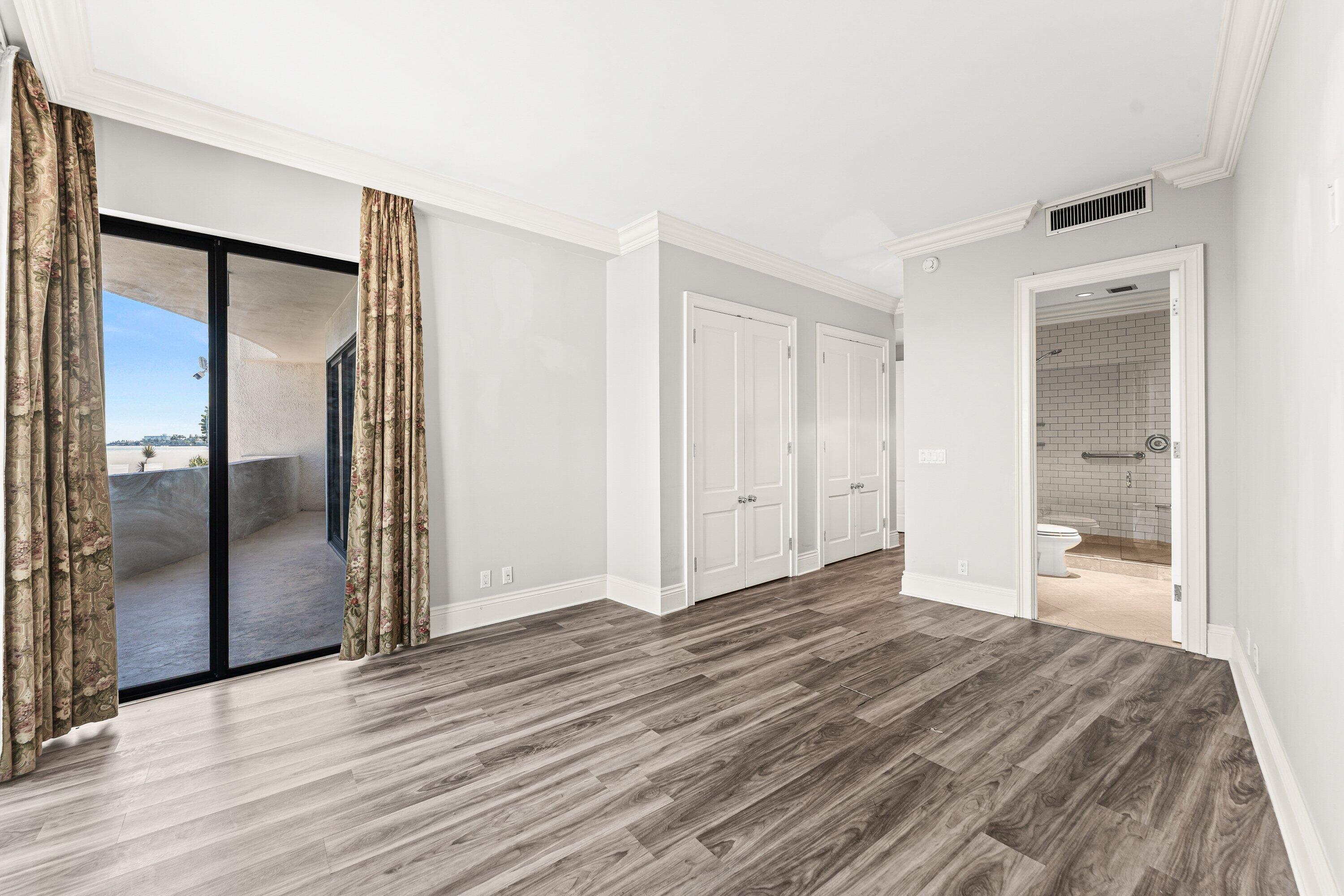 1200 South Flagler Drive, Unit 101 West Palm Beach, FL 33401 - Photo 21 of 44 a view of a room with wooden floor and a bathroom