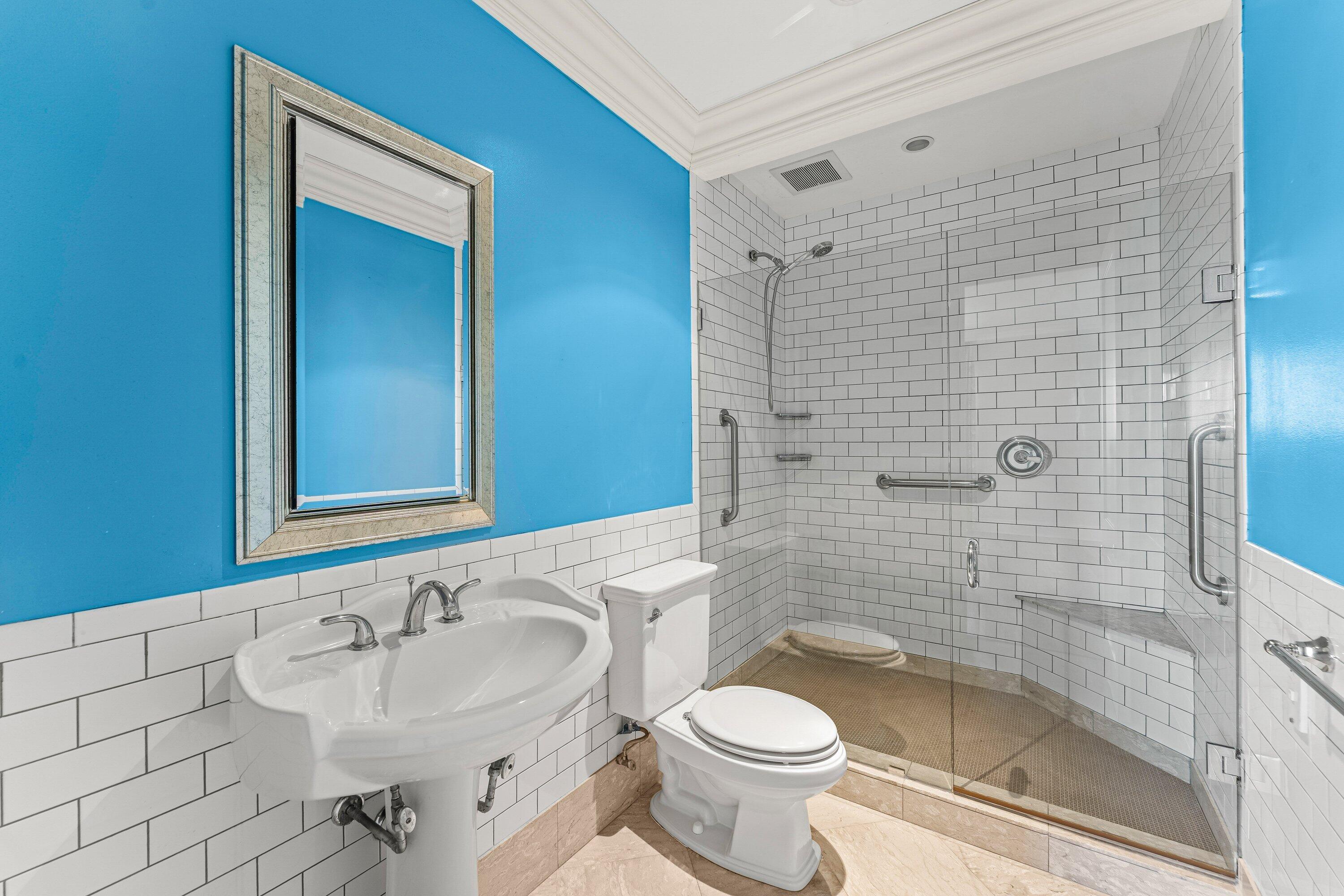 1200 South Flagler Drive, Unit 101 West Palm Beach, FL 33401 - Photo 22 of 44 a bathroom with a sink a toilet and shower