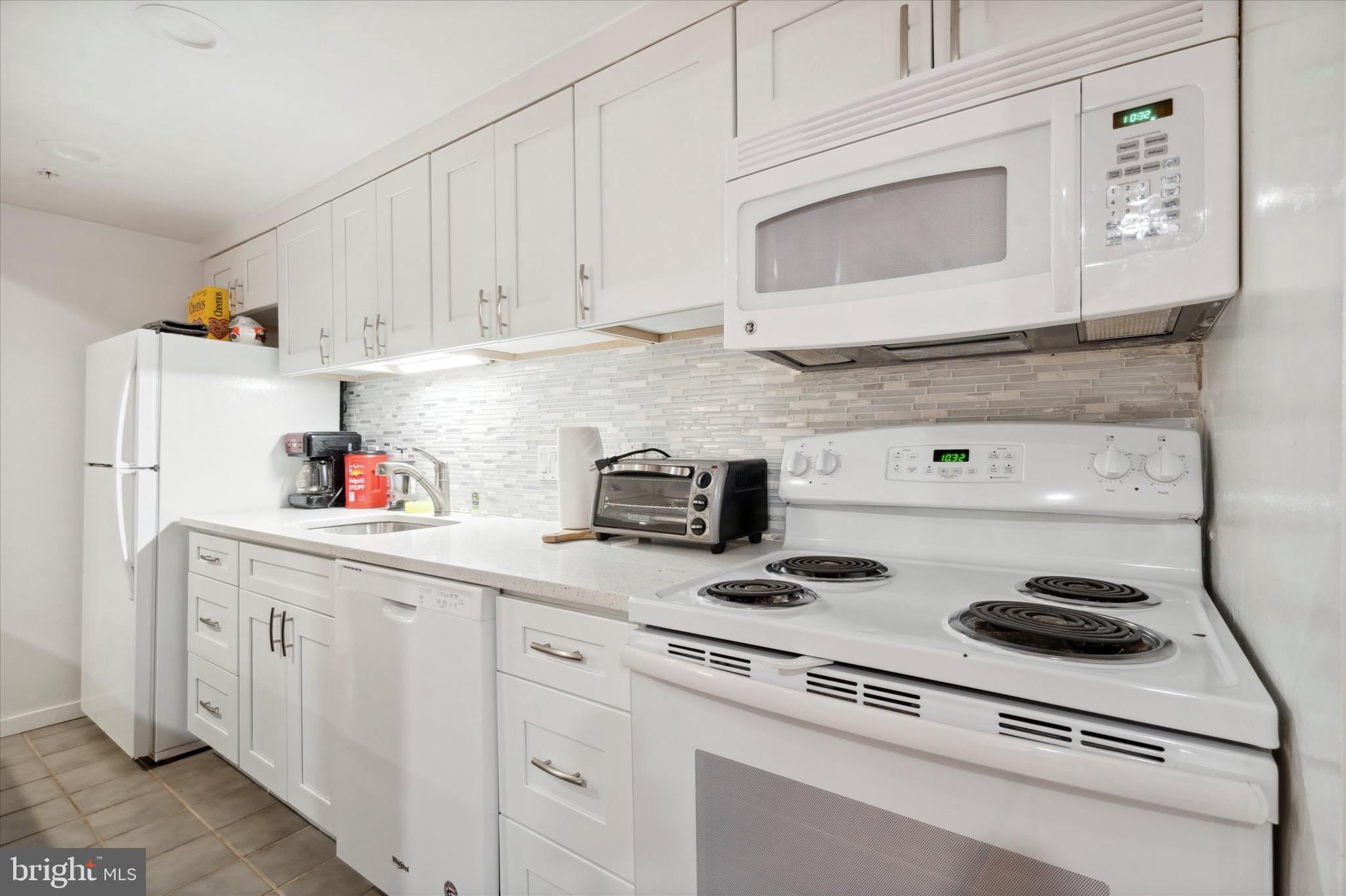12 Letitia Street, Unit 103 Philadelphia, PA 19106 - Photo 18 of 21 a kitchen with white cabinets and white appliances