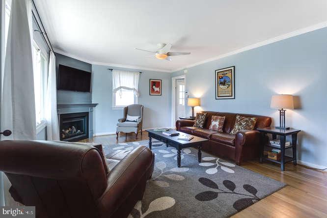7713 Schelhorn Road Alexandria, VA 22306 - Photo 2 of 43 Living room with hardwoods and crown molding.