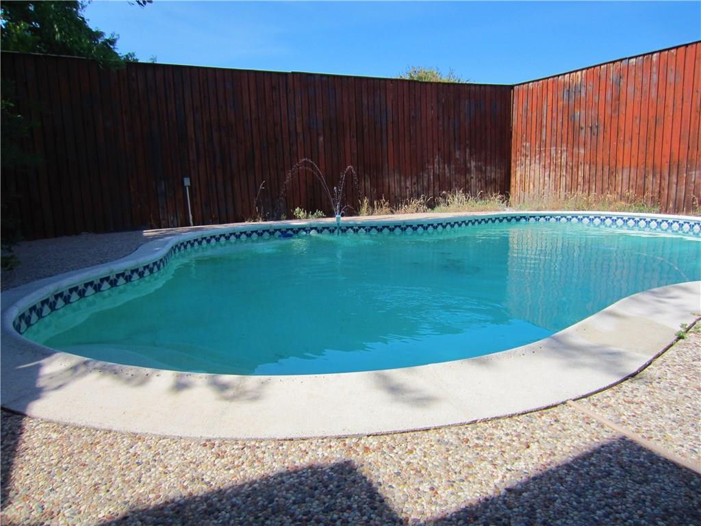 a view of a swimming pool in a backyard