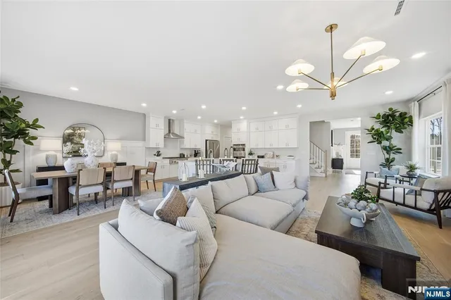 a living room with furniture kitchen view and a dining table