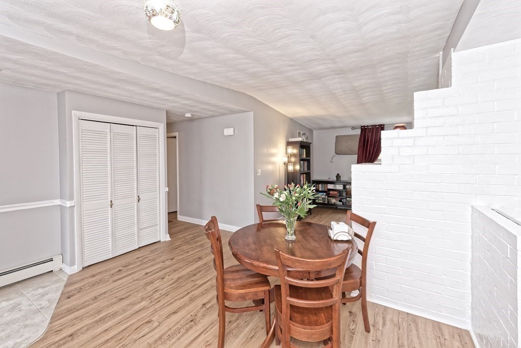 54 Gregory Road Framingham, MA 01701 - Photo 11 of 41 a dining room with furniture and wooden floor