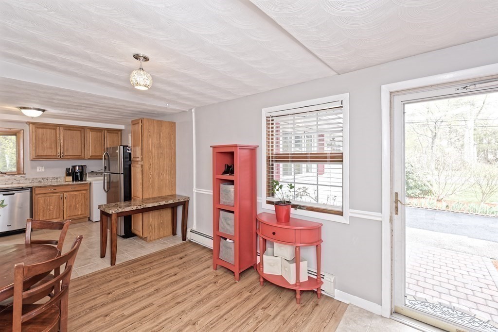 54 Gregory Road Framingham, MA 01701 - Photo 13 of 41 a view of a kitchen with furniture wooden floor and stainless steel appliances