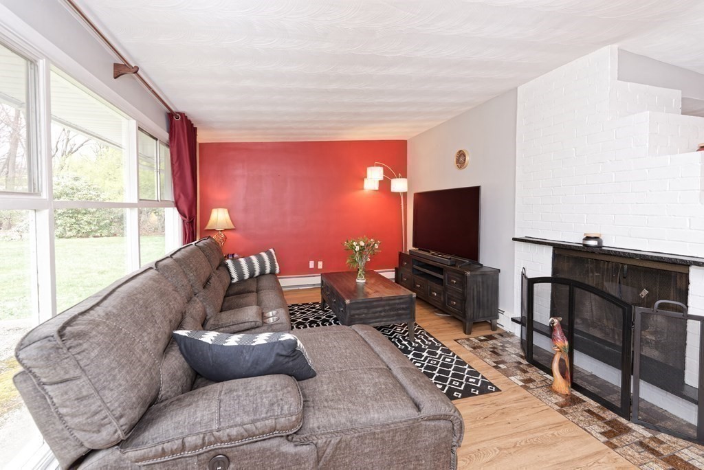 54 Gregory Road Framingham, MA 01701 - Photo 16 of 41 a living room with furniture and a flat screen tv