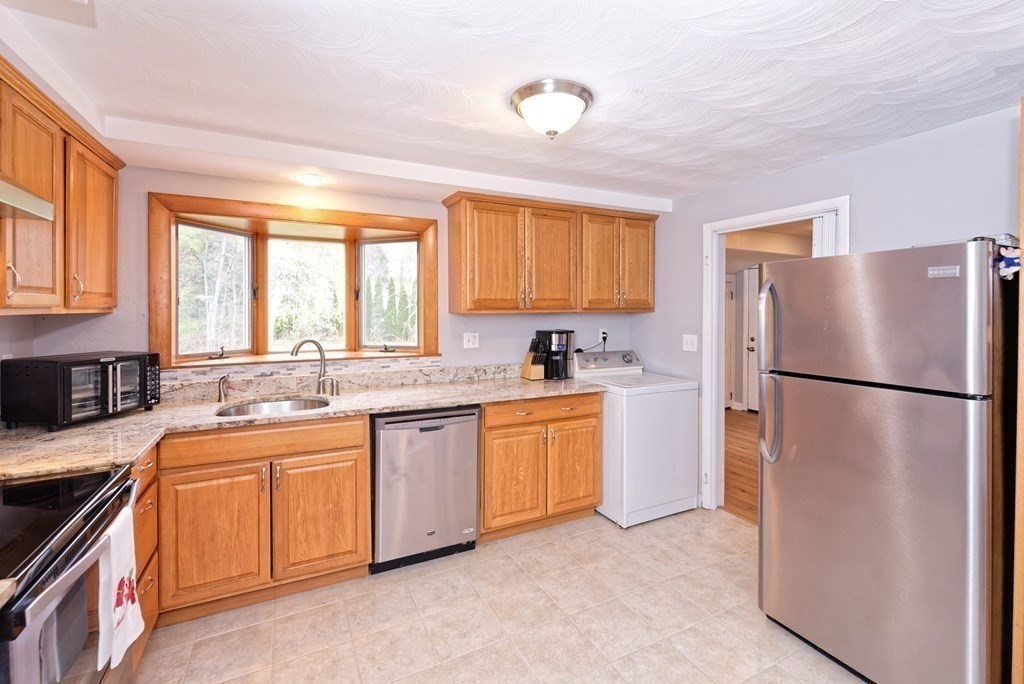 54 Gregory Road Framingham, MA 01701 - Photo 20 of 41 a kitchen with a sink refrigerator and window