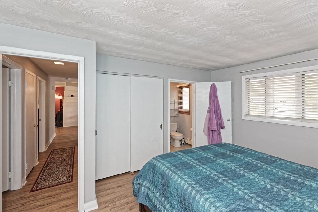 54 Gregory Road Framingham, MA 01701 - Photo 26 of 41 a view of a bedroom with wooden floor and windows