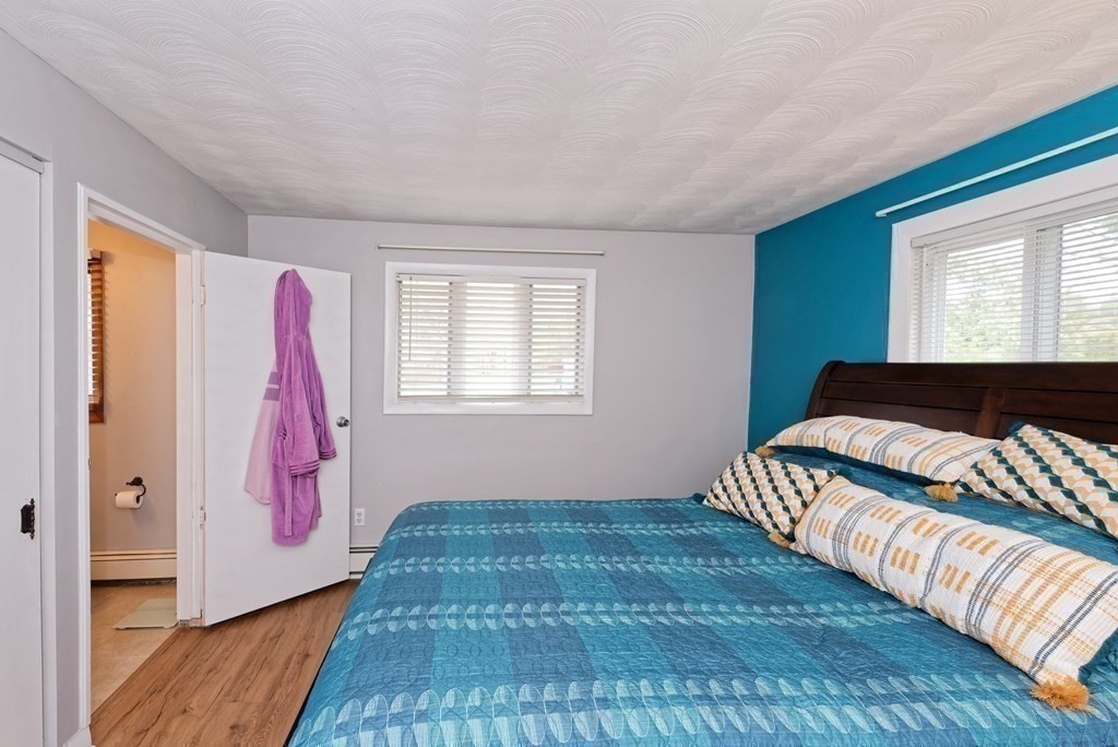 54 Gregory Road Framingham, MA 01701 - Photo 27 of 41 a bedroom with a bed and wooden floor