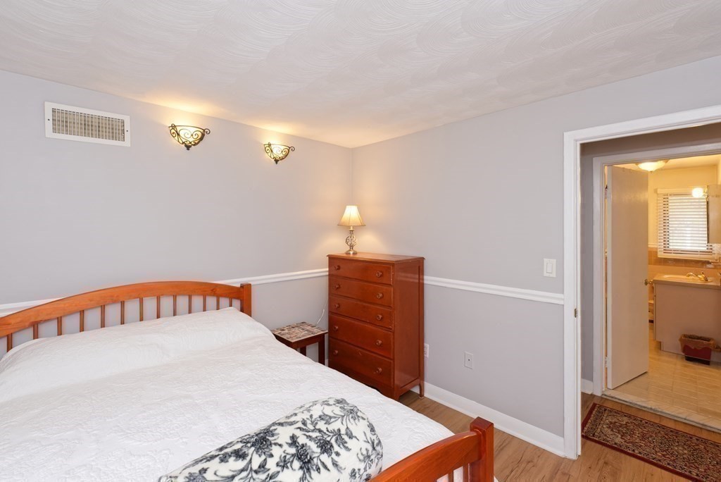 54 Gregory Road Framingham, MA 01701 - Photo 31 of 41 a bedroom with a bed and wooden floor