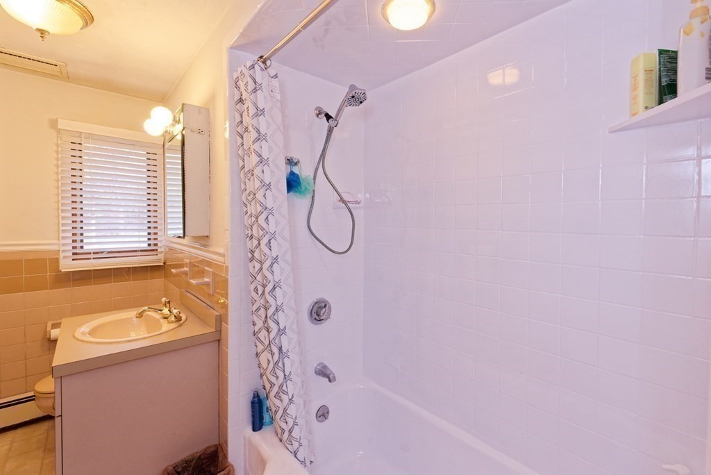 54 Gregory Road Framingham, MA 01701 - Photo 33 of 41 a bathroom with a shower curtain and a window