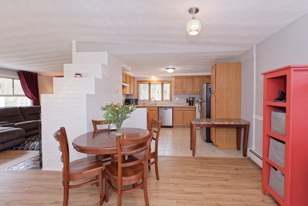 54 Gregory Road Framingham, MA 01701 - Photo 10 of 41 a view of a dining room with furniture and wooden floor