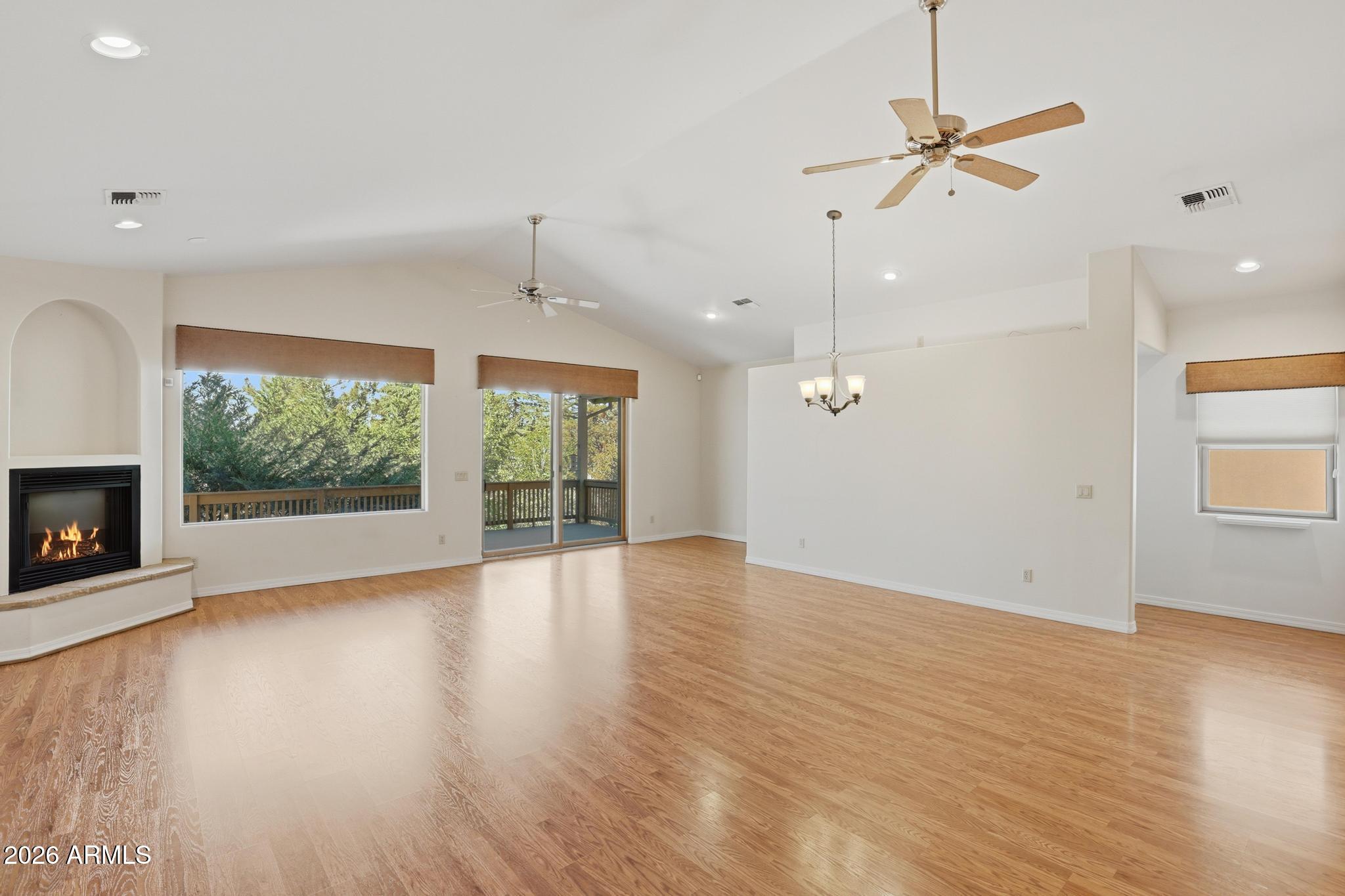 408 East Phoenix Street Payson, AZ 85541 - Photo 9 of 35 an empty room with wooden floor fan and windows
