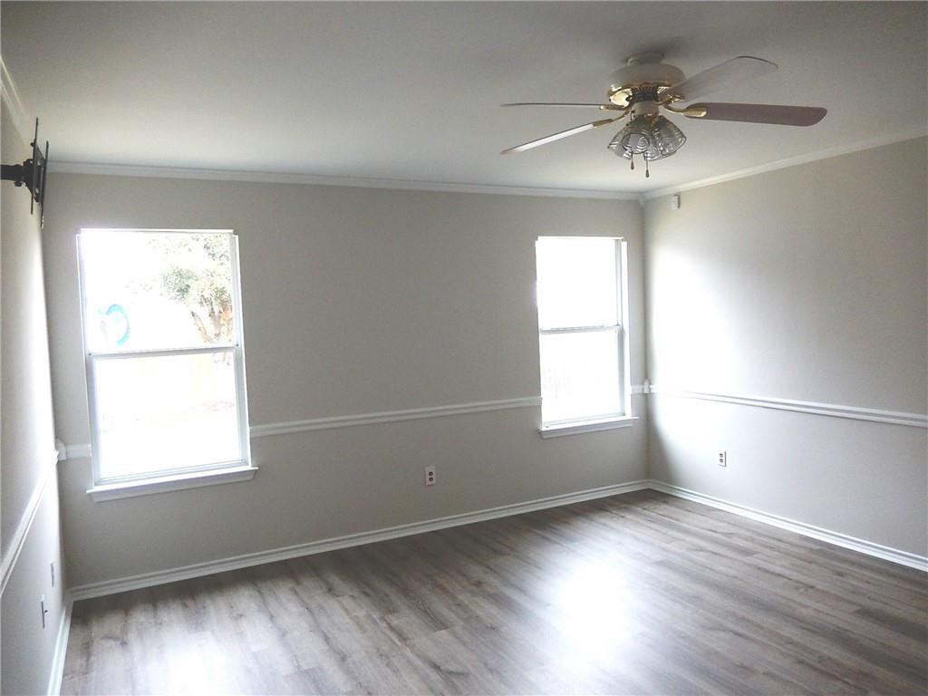 116 Rinehardt Street Hutto, TX 78634 - Photo 11 of 27 an empty room with wooden floor and windows