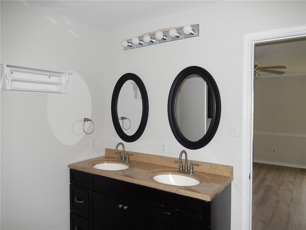 116 Rinehardt Street Hutto, TX 78634 - Photo 14 of 27 a bathroom with a granite countertop sink and a mirror