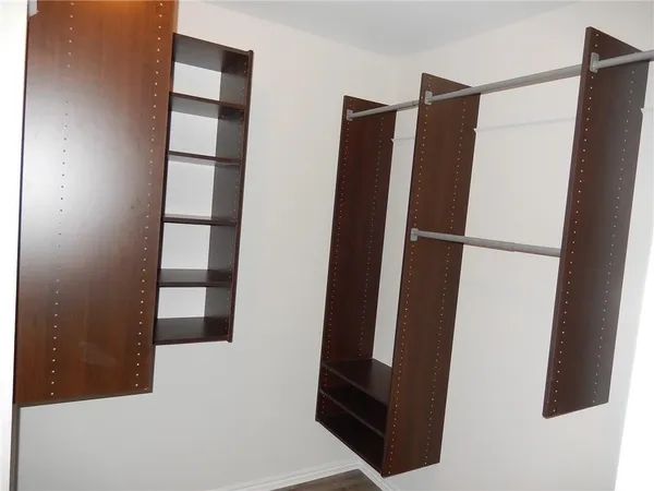 a view of walk in closet with empty tub